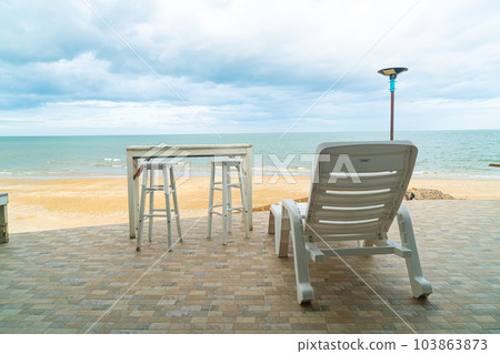 patio outdoor table and chair on beach with sea beach background 103863873