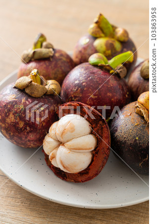 fresh mangosteen on white plate fresh mangosteen on white plate 103863958