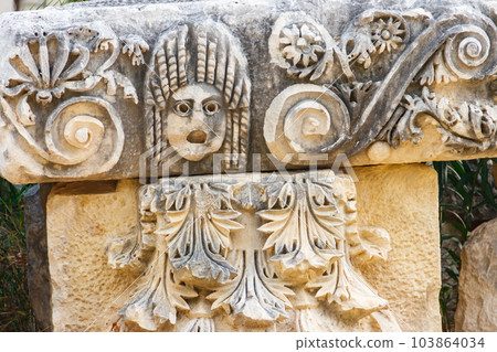 Stone faces in the ancient city of Myra in Demre, Antalya province in Turkey 103864034