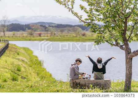 A couple taking a coffee break, waterfront, vintage style A couple taking a coffee break, waterfront, vintage style 103864373