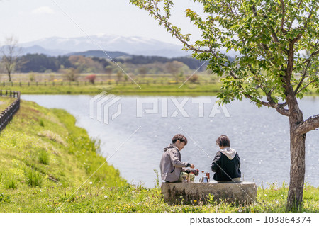 A couple taking a coffee break, waterfront, vintage style A couple taking a coffee break, waterfront, vintage style 103864374