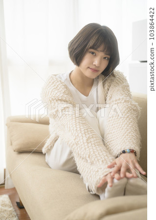 Young woman relaxing on the sofa (black mist filter) Young woman relaxing on the sofa (black mist filter) 103864422
