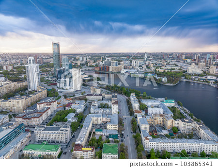 Yekaterinburg city and pond aerial panoramic view at summer sunset. Yekaterinburg city and pond aerial panoramic view at summer sunset. 103865341