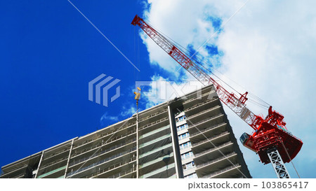 Cityscape with skyscrapers and tower cranes and blue sky Cityscape with skyscrapers and tower cranes and blue sky 103865417