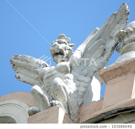 Kiev, Ukraine June 10, 2021: Sculpture of the Griffin - Lion with a female breast and wings on the facade of a building in the center of Kiev Kiev, Ukraine June 10, 2021: Sculpture of the Griffin - Lion with a female breast and wings on the facade of a building in the center of Kiev 103866048