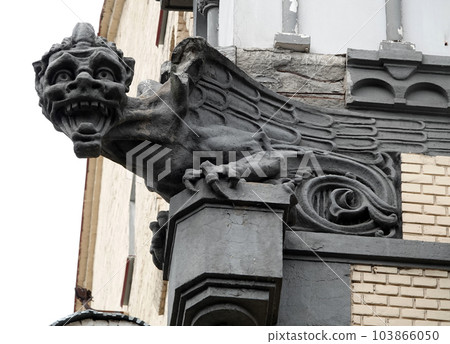 Kiev, Ukraine June 10, 2021: Sculpture of a Griffin in the body of an eagle with wings on the facade of a building in the center of Kiev Kiev, Ukraine June 10, 2021: Sculpture of a Griffin in the body of an eagle with wings on the facade of a building in the center of Kiev 103866050