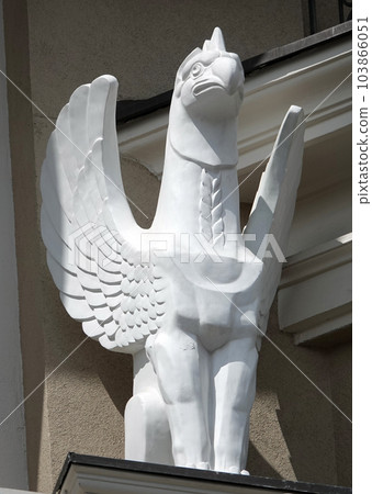 Kiev, Ukraine June 10, 2021: Sculpture of a Griffin eagle head in the body of a lion with wings on the facade of a building in the center of Kiev Kiev, Ukraine June 10, 2021: Sculpture of a Griffin eagle head in the body of a lion with wings on the facade of a building in the center of Kiev 103866051