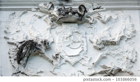 Kiev, Ukraine June 10, 2021: Sculptures of Griffins with a coat of arms on the facade of a building in the center of Kiev 103866056