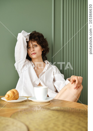 Portrait of cute woman having breakfast Portrait of cute woman having breakfast 103866630