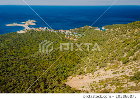 Aerial view of sea with coastline, village and mediterranean forest. Aerial view of sea with coastline, village and mediterranean forest. 103866873