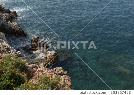 Wild coast of Cap de Nice on a warm spring day Wild coast of Cap de Nice on a warm spring day 103867438