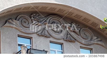 Kiev, Ukraine July 11, 2021: Architectural decoration of the stucco facade of a building in the city of Kiev Kiev, Ukraine July 11, 2021: Architectural decoration of the stucco facade of a building in the city of Kiev 103867498