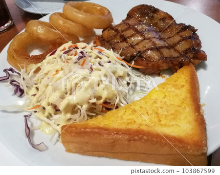 Chicken Steak Vegetable Salad Fried Onion Garlic Bread on White Plate. 103867599