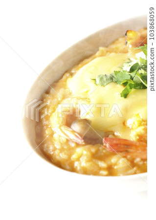 Shrimp, cheese, coriander, hot tom yum risotto shot against a white background 103868059