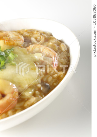 Shrimp, cheese, coriander, hot tom yum risotto shot against a white background Shrimp, cheese, coriander, hot tom yum risotto shot against a white background 103868060