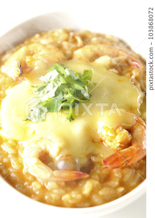Shrimp, cheese, coriander, hot tom yum risotto shot against a white background Shrimp, cheese, coriander, hot tom yum risotto shot against a white background 103868072