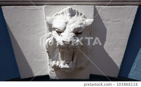 Kiev, Ukraine June 10, 2021: The facade of an ancient building decorated with a plaster lion in the center of Kiev Kiev, Ukraine June 10, 2021: The facade of an ancient building decorated with a plaster lion in the center of Kiev 103868118
