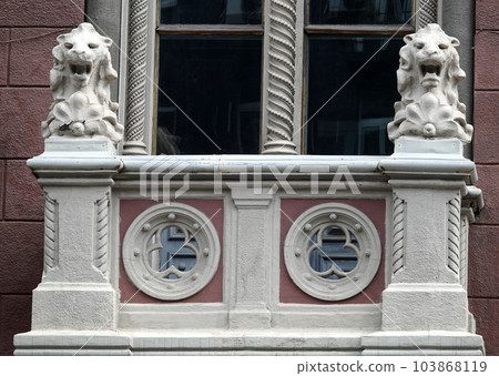 Kiev, Ukraine June 10, 2021: The facade of an ancient building decorated with a plaster lion in the center of Kiev Kiev, Ukraine June 10, 2021: The facade of an ancient building decorated with a plaster lion in the center of Kiev 103868119