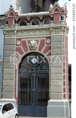 Kiev, Ukraine June 10, 2021: The facade of an ancient building decorated with a plaster lion in the center of Kiev Kiev, Ukraine June 10, 2021: The facade of an ancient building decorated with a plaster lion in the center of Kiev 103868120