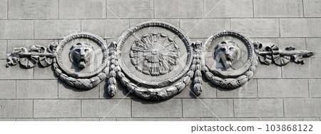 Kiev, Ukraine June 10, 2021: The facade of an ancient building decorated with a plaster lion in the center of Kiev Kiev, Ukraine June 10, 2021: The facade of an ancient building decorated with a plaster lion in the center of Kiev 103868122