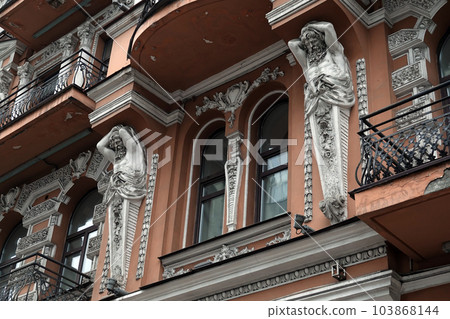 Kiev, Ukraine November 28, 2020: Artistic decoration of the facade of the building with sculptures and busts of Atlantes in the city of Kiev 103868144