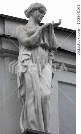 Kiev, Ukraine November 28, 2020: Artistic decoration of the facade of the building with sculptures and busts of people in the city of Kiev 103868161