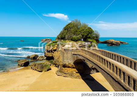 Stone bridge to the Rocher du Basta, the scenic rock and major landmark in the coast of Biarritz 103868803