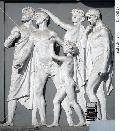 Kiev, Ukraine June 10, 2020: Artistic decoration of the facade of the building with sculptures of people in the city of Kiev Kiev, Ukraine June 10, 2020: Artistic decoration of the facade of the building with sculptures of people in the city of Kiev 103868983