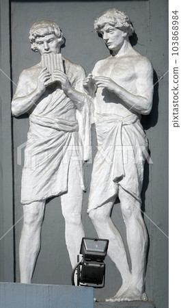 Kiev, Ukraine June 10, 2020: Artistic decoration of the facade of the building with sculptures of people in the city of Kiev 103868984