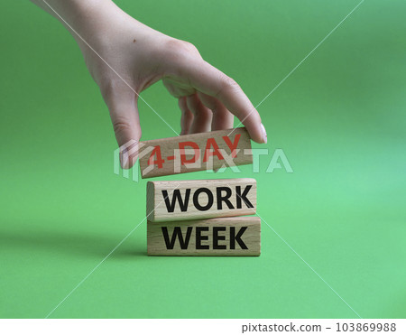 4-day work week symbol. Concept words 4-day work week on wooden blocks. Beautiful green background. Businessman hand. Business and 4-day work week concept. Copy space 103869988