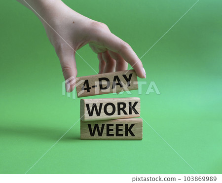 4-day work week symbol. Concept words 4-day work week on wooden blocks. Beautiful green background. Businessman hand. Business and 4-day work week concept. Copy space 4-day work week symbol. Concept words 4-day work week on wooden blocks. Beautiful green background. Businessman hand. Business and 4-day work week concept. Copy space 103869989