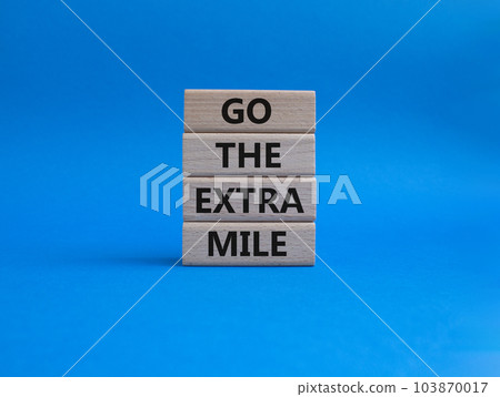 Go the extra mile symbol. Wooden blocks with words Go the extra mile. Beautiful blue background. Business and Go the extra mile concept. Copy space. Go the extra mile symbol. Wooden blocks with words Go the extra mile. Beautiful blue background. Business and Go the extra mile concept. Copy space. 103870017