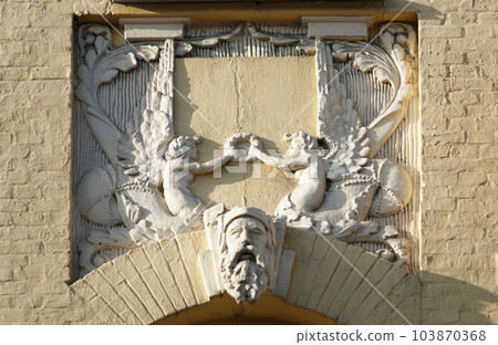 Kiev, Ukraine November 28, 2020: Artistic decoration of the facade of the building with sculptures and busts of Atlantes in the city of Kiev Kiev, Ukraine November 28, 2020: Artistic decoration of the facade of the building with sculptures and busts of Atlantes in the city of Kiev 103870368