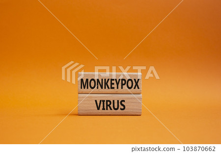 Monkeypox virus symbol. Concept word Monkeypox virus on wooden blocks. Beautiful orange background. Medicine and Monkeypox virus concept. Copy space 103870662