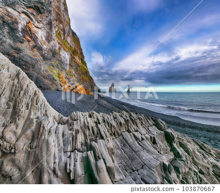 landscape with basalt rock formations Troll Toes on Black beach Reynisfjara near the village of Vik 103870667