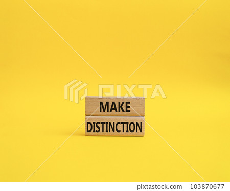 Make distinction symbol. Concept words make distinction on wooden blocks. Beautiful yellow background. Business and make distinction concept. Copy space. Make distinction symbol. Concept words make distinction on wooden blocks. Beautiful yellow background. Business and make distinction concept. Copy space. 103870677