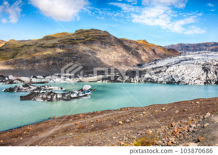 Breathtaking view on Solheimajokull glacier in Katla Geopark on Icelandic Atlantic South Coast. 103870686