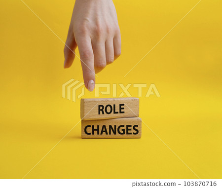 Role changes symbol. Concept words Role changes on wooden blocks. Beautiful yellow background. Businessman hand. Business and Role changes concept. Copy space. Role changes symbol. Concept words Role changes on wooden blocks. Beautiful yellow background. Businessman hand. Business and Role changes concept. Copy space. 103870716