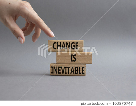 Change is Inevitable symbol. Wooden blocks with words Change is Inevitable. Beautiful grey background. Businessman hand. Business and Change is Inevitable concept. Copy space. 103870747
