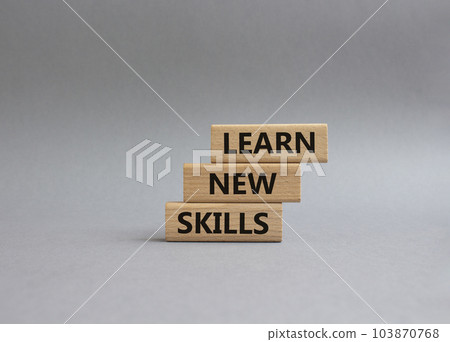Learn new skills symbol. Concept words 'Learn new skills' on wooden blocks. Beautiful grey background. Business and Learn new skills concept. Copy space. Learn new skills symbol. Concept words 'Learn new skills' on wooden blocks. Beautiful grey background. Business and Learn new skills concept. Copy space. 103870768