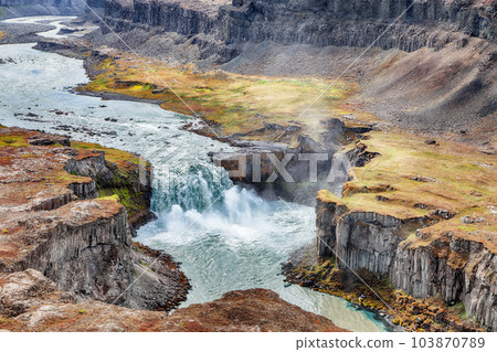 Breathtaking view of canyon and waterfall Hafragilsfoss. Breathtaking view of canyon and waterfall Hafragilsfoss. 103870789