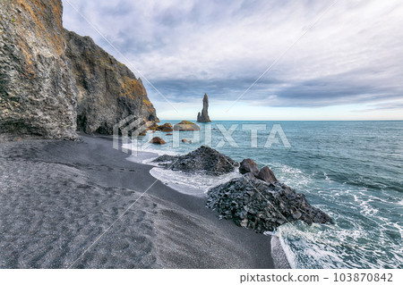 Breathtaking view of rock formations Troll Toes on Black beach Reynisfjara near the village of Vik. Breathtaking view of rock formations Troll Toes on Black beach Reynisfjara near the village of Vik. 103870842