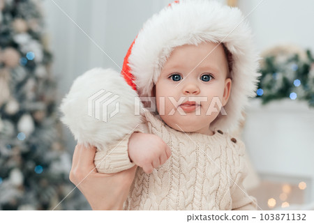 Little child under Christmas tree. baby boy with gifts under Christmas tree with many gift boxes presents. Happy Holidays, New year. Cozy warm winter evening at home. Xmas time Little child under Christmas tree. baby boy with gifts under Christmas tree with many gift boxes presents. Happy Holidays, New year. Cozy warm winter evening at home. Xmas time 103871132