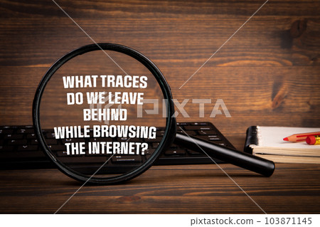 Traces in the Internet Concept. Computer keyboard on a wooden office table Traces in the Internet Concept. Computer keyboard on a wooden office table 103871145