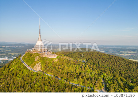 Sunny evening at Jested Mountain with unique building on the summit. Liberec, Czech Republic. Aerial view from drone. 103871180