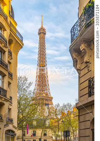 View of the Eiffel Tower from a nearby street full of residential buildings. Paris, France 103871184