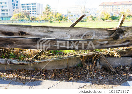 Falling down and damaged wooden fence in city Falling down and damaged wooden fence in city 103871537