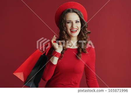 happy elegant female isolated on background with shopping bags 103871996