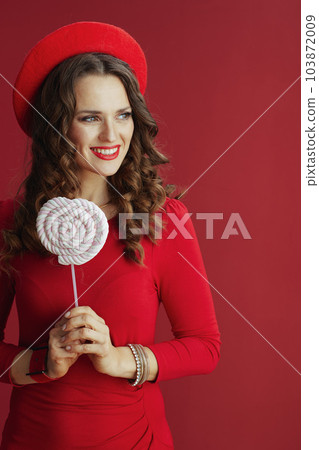 smiling woman in dress and beret isolated on background 103872009