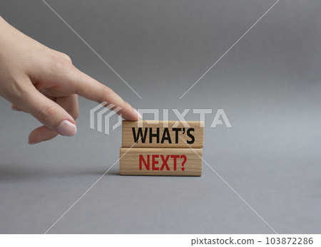 What is next symbol. Concept word What is next on wooden blocks. Beautiful grey background. Businessman hand. Business and What is next concept. Copy space What is next symbol. Concept word What is next on wooden blocks. Beautiful grey background. Businessman hand. Business and What is next concept. Copy space 103872286
